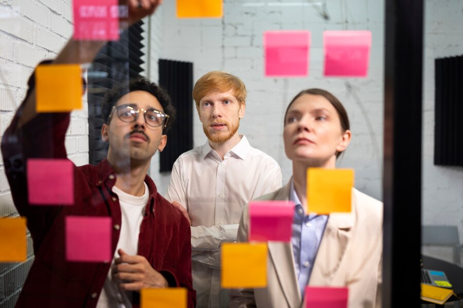 medium-shot-people-looking-post-its_23-2149362915